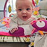 baby, infant, play_mat, toy, colorful, indoors, child, cute, smiling, face, hand, soft_toy, crawling, floor, bright, happy, toddler, person, closeup, expression