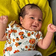 Elijah participe au concours pour gagner de l'argent avec cette photo : baby, infant, smile, floral_onesie, yellow_cushion, plush_toy, gray_bunny, raised_arms, happy, cute, lying_down, soft_toy, child, indoors, portrait, closeup, baby_clothing, fabric, skin, head