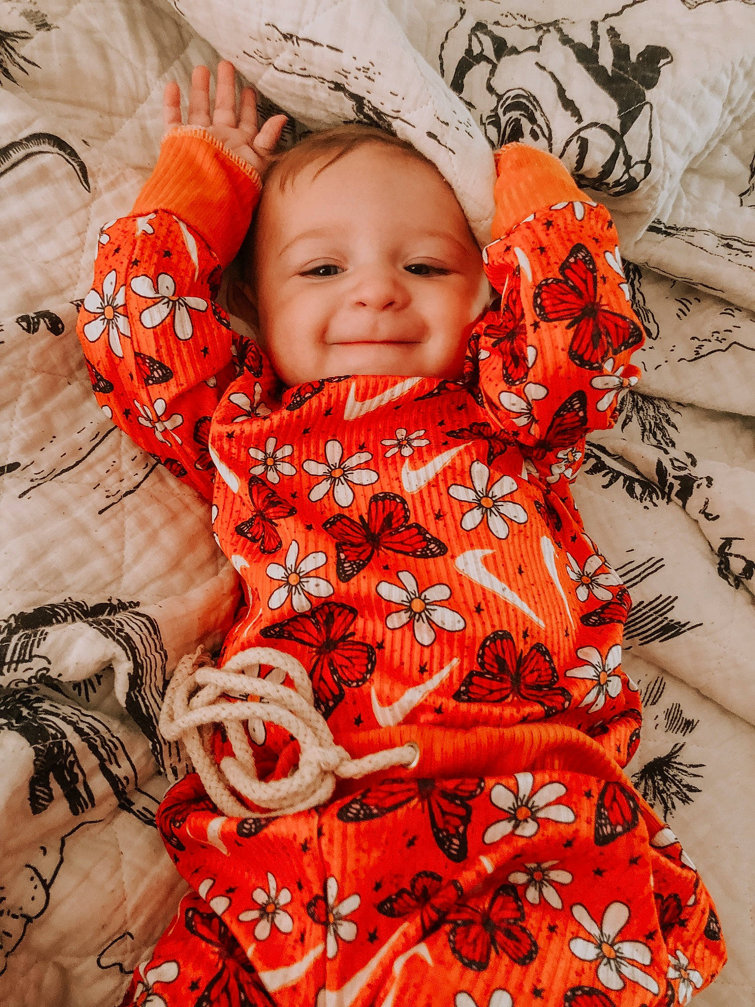 Lakelynn is registered to the contest to win money with this photo: baby, baby_toddler_clothing, beauty, child, eye, facial_expression, happy, head, human, linens, orange, pattern, people, person, pink, plant, skin, sleeve, smile, textile