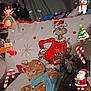 blue_shirt, candy_cane, cat, christmas, christmas_tree, cute, decorations, festive, gift, grinch, holiday, indoor, orange_cat, pillow, reindeer, relaxed, santa_claus, snowflakes, snowman, stocking