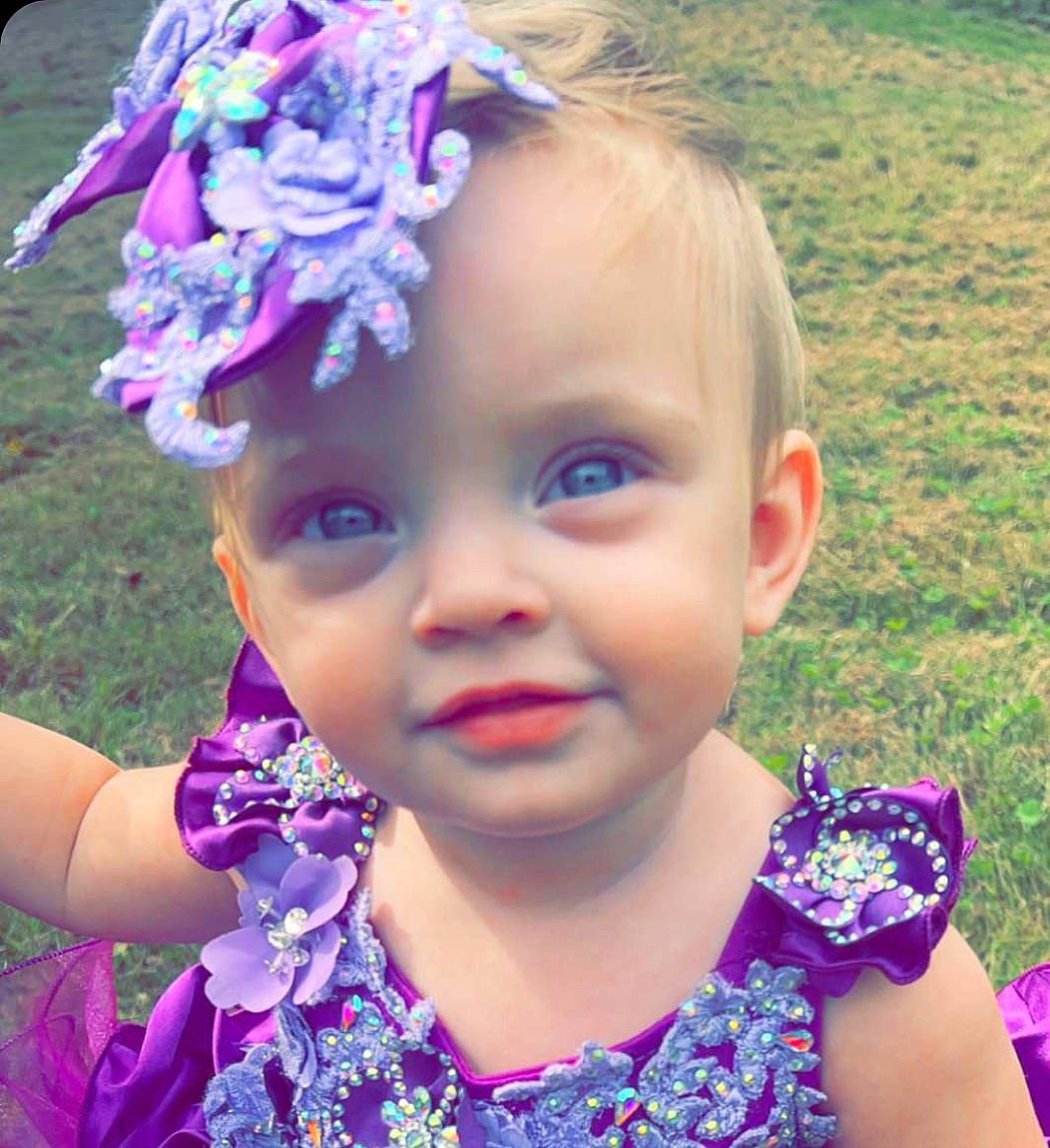 Presley joined the competition — help win amazing prizes! baby_toddler_clothing, blue, child, cool, eyelash, face, facial_expression, grass, happy, headgear, iris, joy, person, petal, photograph, pink, plant, purple, skin, smile