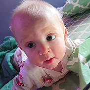 Bonnie Jo joined the competition — help win amazing prizes! baby, bed, bedding_pattern, big_eyes, blanket, child, closeup, curious_expression, cute, face, hair, indoors, infant, mouth, pajamas, pillow, portrait, santa_print, skin, soft_lighting