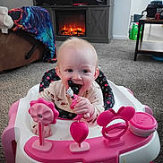 Bonnie Jo joined the competition — help win amazing prizes! baby, infant, child, pink_walker, minnie_mouse_toy, teether, smiling, chewing, playtime, living_room, fireplace, television, carpet, blanket, sofa, home_interior, hands, face, cute, plastic_toy