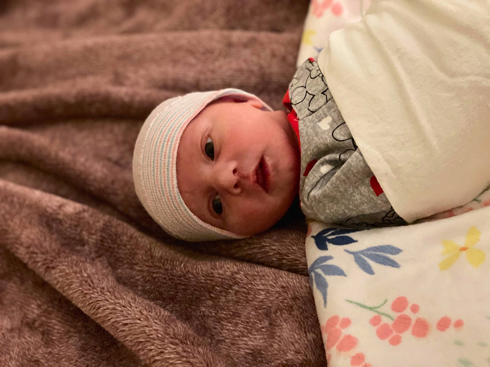 Austyn is registered to the contest to win money with this photo: baby, bedding, bedtime, comfort, couch, eye, face, fur, headgear, headwear, human_body, linens, nose, outerwear, person, room, skin, sleeve, textile, toddler