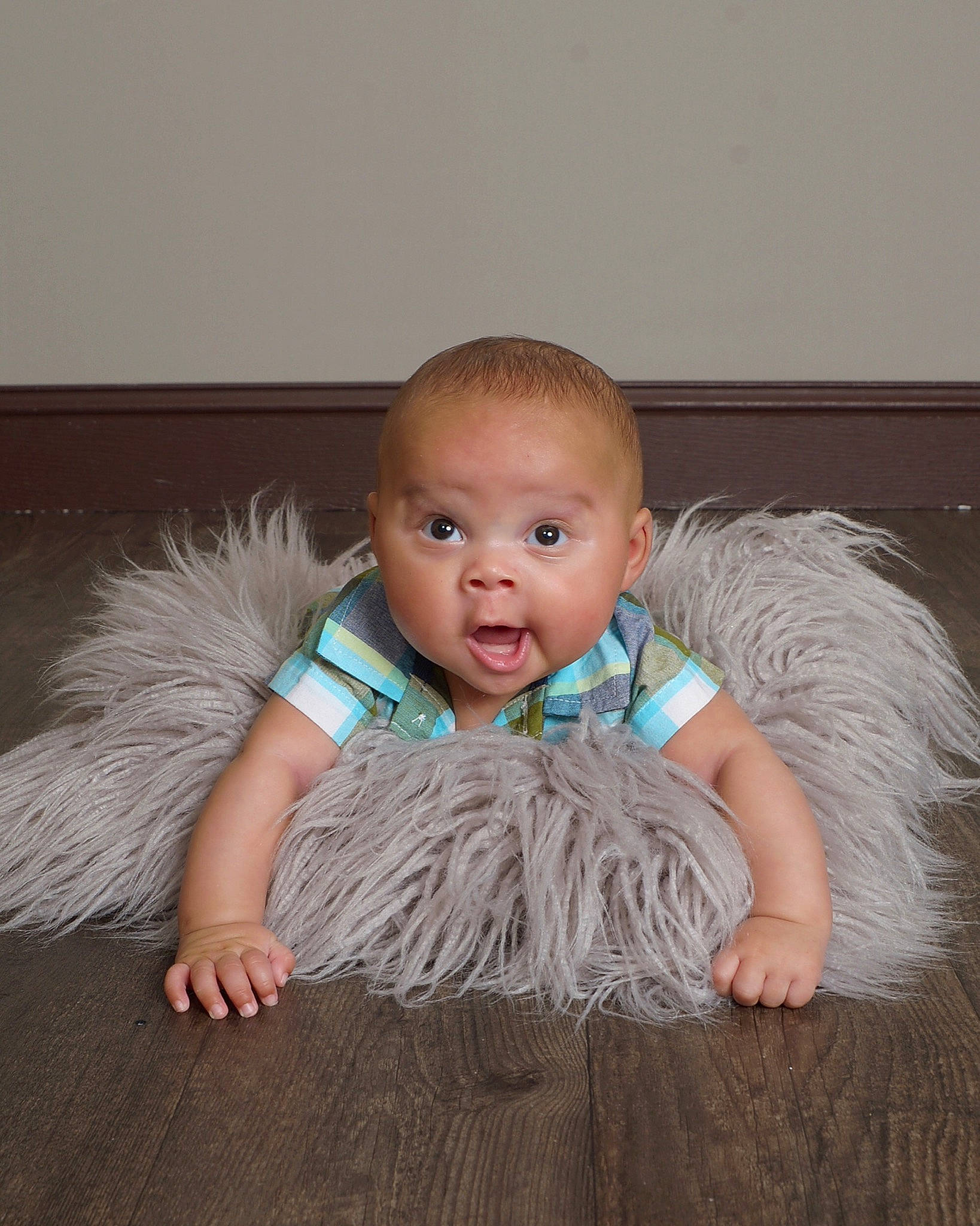 Jonathon is registered to the contest to win money with this photo: baby, baby_toddler_clothing, child, costume, floor, flooring, fur, head, iris, person, sitting, skin, toddler, wood, wood_flooring