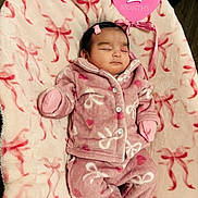 Glenis is registered to the contest to win money with this photo: baby, sleeping, pink_clothing, pajamas, blanket, patterned_blanket, heart_shaped_sign, milestone, infant, cute, peaceful, indoors, soft_texture, newborn, child, lying_down, warm_clothing, pink, small_hair_clip, cozy