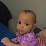 Skyler is registered to the contest to win money with this photo: baby, infant, child, purple_clothing, tie_dye, heart_emoji, indoor, person, cute, resting, close_up, face, portrait, human, looking_at_camera, hand, skin, young_child, expression, cozy