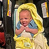 baby, blanket, blue_shirt, car_seat, child, clothing, cute, happy, indoors, infant, newborn, pacifier, person, seat, small, smiling, tongue_out, wrapped, yellow, young