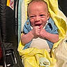 baby, blanket, blue_shirt, car_seat, clothing, cute, face, hands, happy, head, indoors, infant, laughing, newborn, pacifier, person, skin, smiling, texture, yellow_blanket