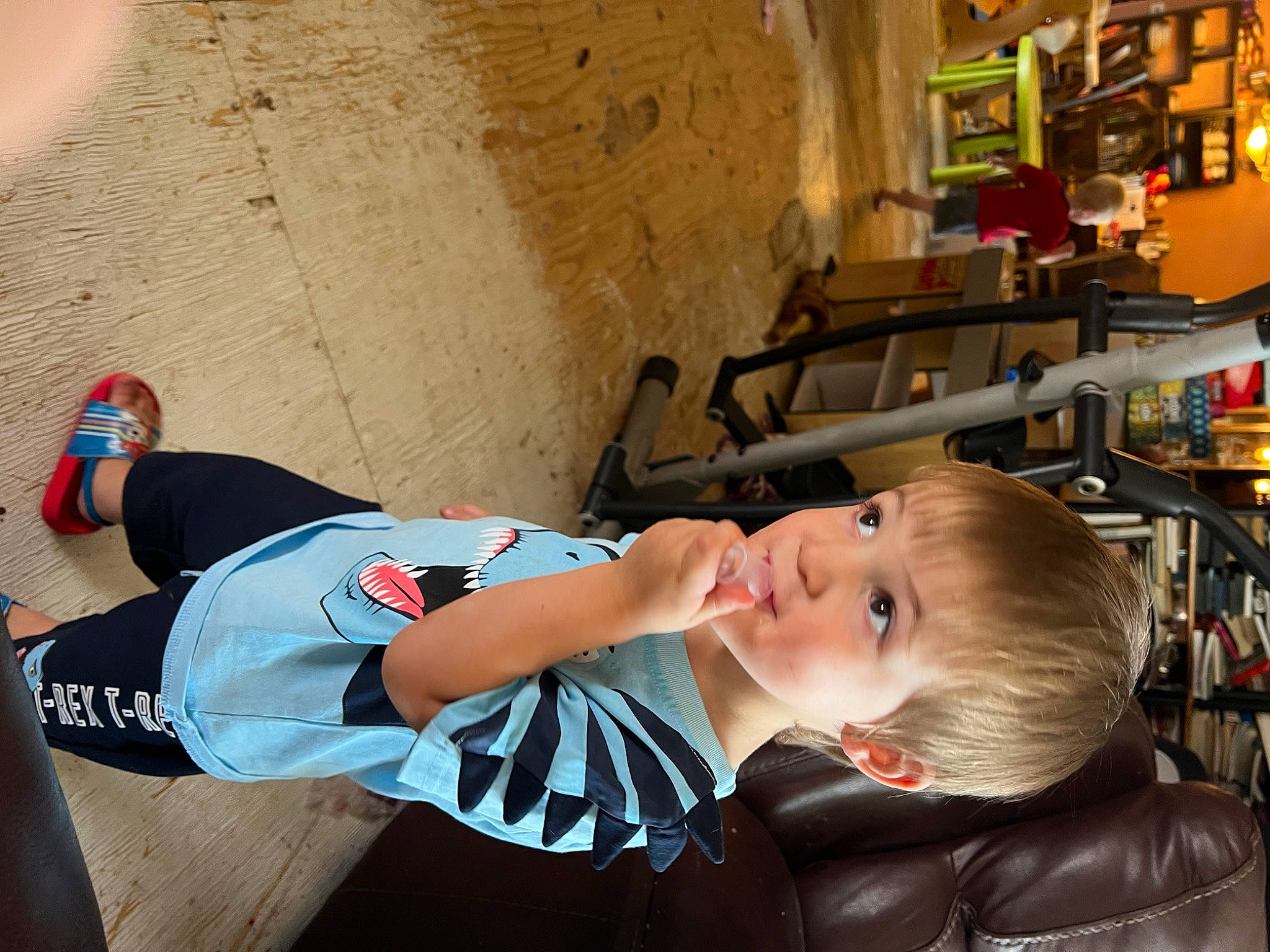 Alaster is registered to the contest to win money with this photo: baby, baby_products, child, eyewear, fun, glasses, human_leg, knee, leisure, person, personal_protective_equipment, room, shelf, sitting, sock, sportswear, suit, thigh, toddler