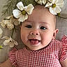 Mai joined the competition — help win amazing prizes! baby, infant, smiling, happy, face, flower, white_flower, head, gown, red_clothing, patterned_clothing, cheek, skin, cute, child, portrait, closeup, nature, greenery, lying_down