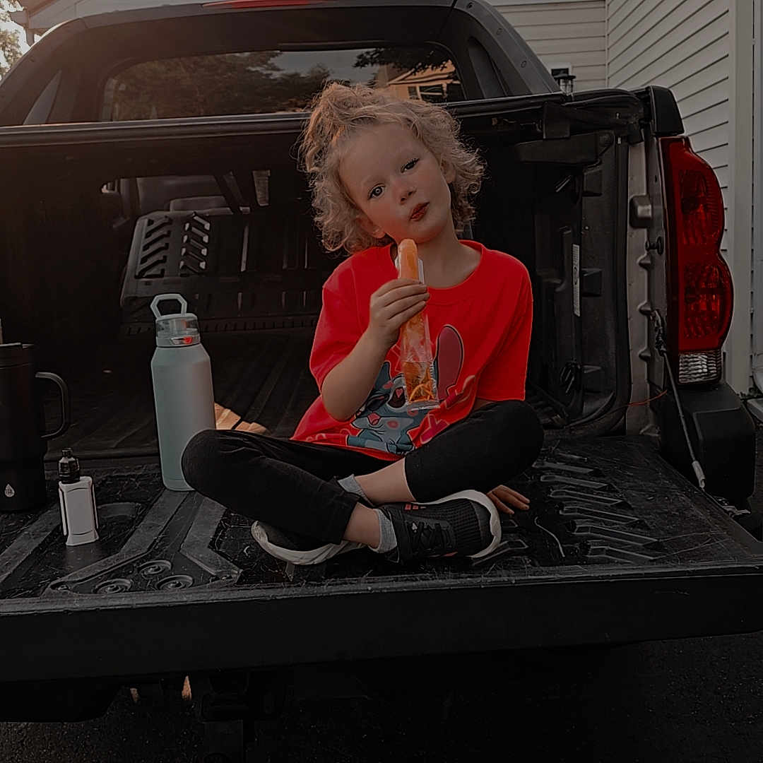 Taylyn is registered to the contest to win money with this photo: bodypart, car, child, clothing, cream, dessert, eating, face, female, finger, food, footwear, girl, head, icecream, person, shoe, sweets, transportation, vehicle