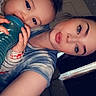 Kylo is registered to the contest to win money with this photo: child, toddler, adult, woman, selfie, portrait, indoor, vehicle, seated, bottle, drinking, baby, curly_hair, facial_expression, heart_emoji, casual_clothing, close_up, companion, photograph, family