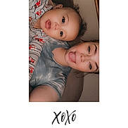 Kylo joined the competition — help win amazing prizes! child, toddler, adult, selfie, portrait, smiling, playful, tongue_out, curly_hair, family, closeup, indoors, couch, casual_clothing, pajamas, headshot, face, two_people, white_background, handwritten_text
