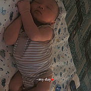 Kylo joined the competition — help win amazing prizes! newborn, baby, infant, sleeping, lying_down, portrait, face, closed_eyes, blanket, crib, onesie, striped_clothing, bedroom, indoor, cozy, peaceful, cute, baby_feet, soft_lighting, text_overlay