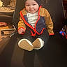 baby, child, infant, smiling, portrait, sitting, gaming_chair, jacket, hood, shoes, sneakers, clothing, indoors, home, furniture, 暖色_lighting, happy, cute, front_view, photography