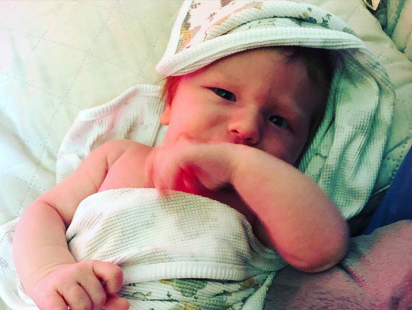 Eric is registered to the contest to win money with this photo: baby, baby_sleeping, cheek, chin, comfort, eye, eyebrow, eyelash, face, finger, gesture, hand, happy, head, headwear, human_body, lip, mouth, nose, person