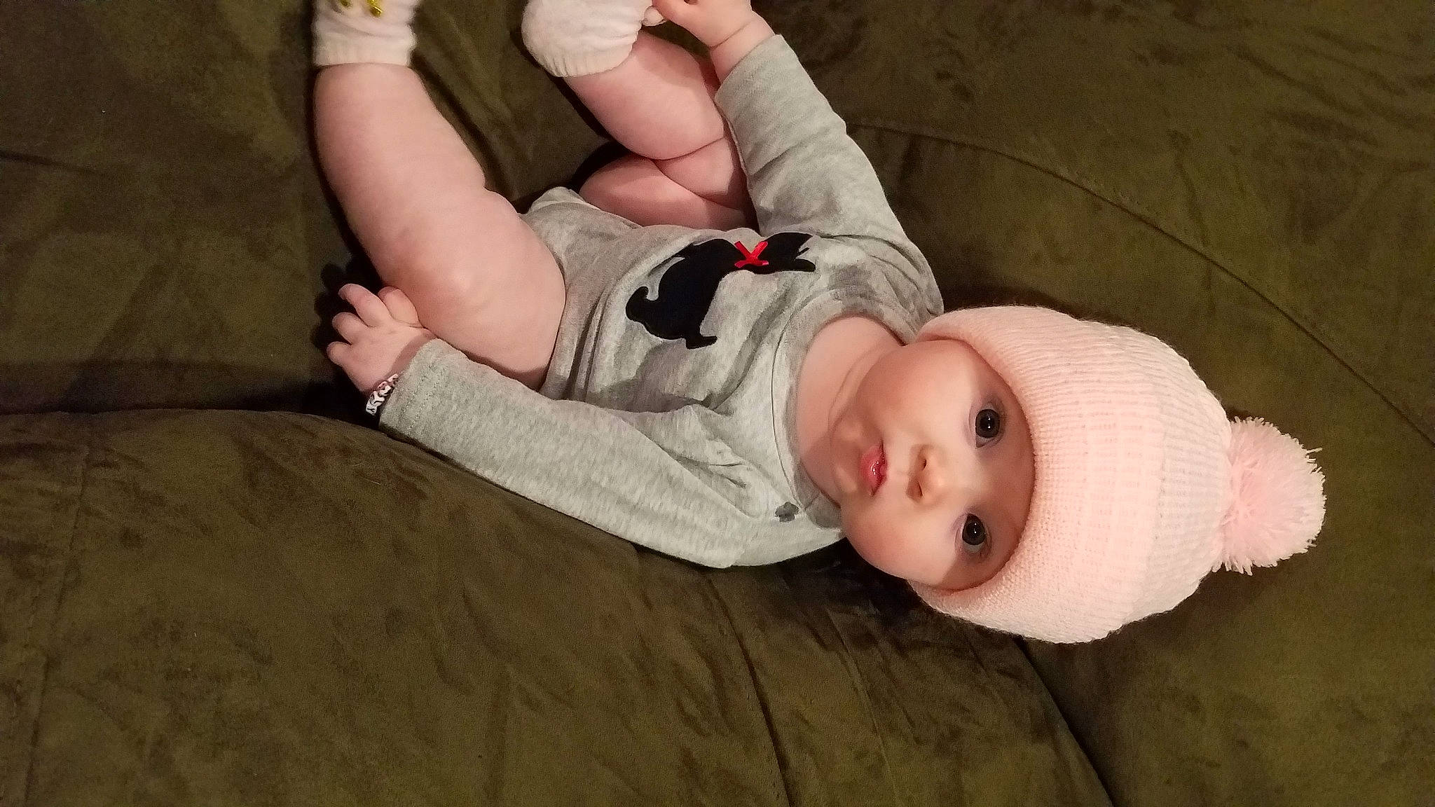 Evalyn is registered to the contest to win money with this photo: arm, baby, baby_toddler_clothing, child, comfort, elbow, eye, face, finger, foot, hand, head, headwear, human_body, human_leg, knee, leg, person, skin, thigh