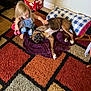 barefoot, blanket, blonde_hair, box, brindle, carpet, child, diapers, dog, floor, furniture, home, indoor, pet, pillow, plaid, playing, purple_blanket, sippy_cup, toy