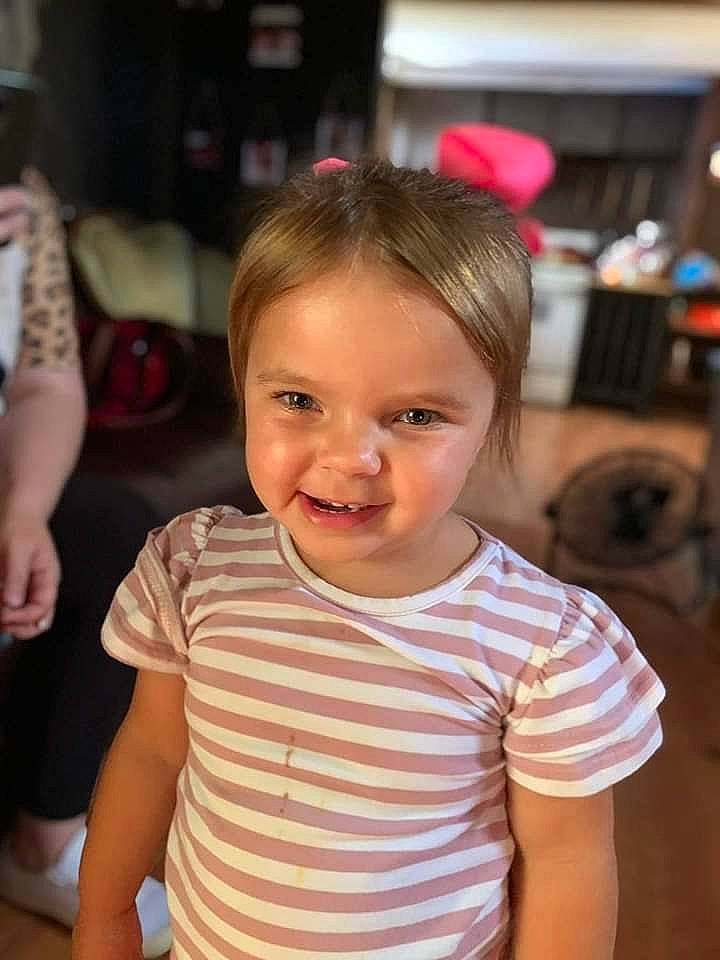 Briella is registered to the contest to win money with this photo: baby_toddler_clothing, cheek, child, chin, eye, face, facial_expression, flooring, fun, hairstyle, happy, head, iris, nose, person, skin, sleeve, smile, standing, t_shirt