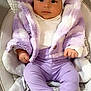 Ariana is registered to the contest to win money with this photo: baby, infant, child, headband, bow, purple_clothing, jacket, pants, pink_socks, baby_seat, soft_toys, cute, portrait, indoors, smiling, cozy, comfortable, face, hands, feet
