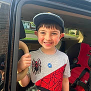 Elliot joined the competition — help win amazing prizes! child, boy, smile, cap, tshirt, spiderman, car, car_door, car_seat, seatbelt, hand, window, sunlight, outdoor, happy, portrait, vehicle_interior, casual_clothing, young, person