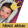 baby, child, face, portrait, crown_graphic, text_overlay, cushion, striped_clothing, closeup, indoor, soft_lighting, cute, young_child, head_support, pink_background, glitter_texture, large_eyes, curly_hair, resting, adorable