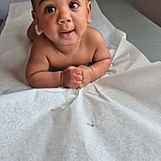 Ahisiah joined the competition — help win amazing prizes! baby, infant, curly_hair, big_eyes, medical_table, paper_cover, skin, child, cute, portrait, indoors, expression, hands, lying_down, young_child, looking_up, healthcare, examination, room, curiosity
