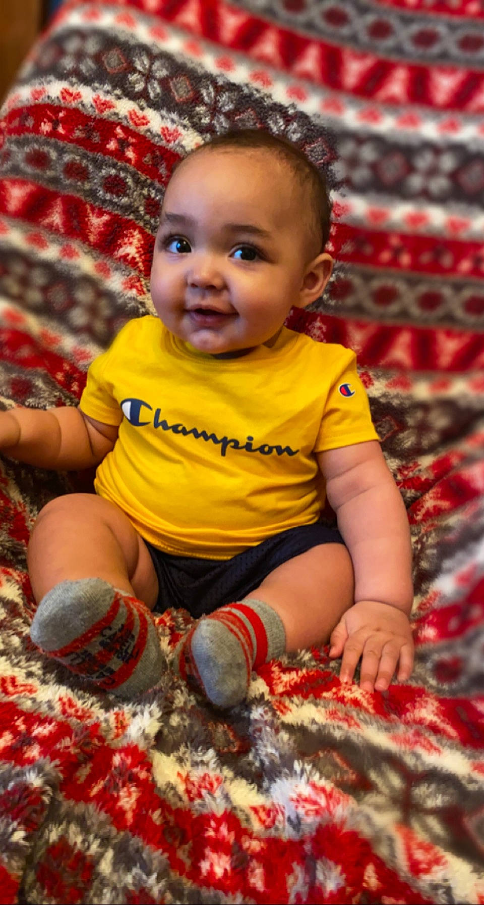 Myles is registered to the contest to win money with this photo: baby_toddler_clothing, cheek, eye, face, facial_expression, grass, hairstyle, happy, head, human_body, iris, leaf, orange, organ, people_in_nature, person, photograph, plant, red, skin