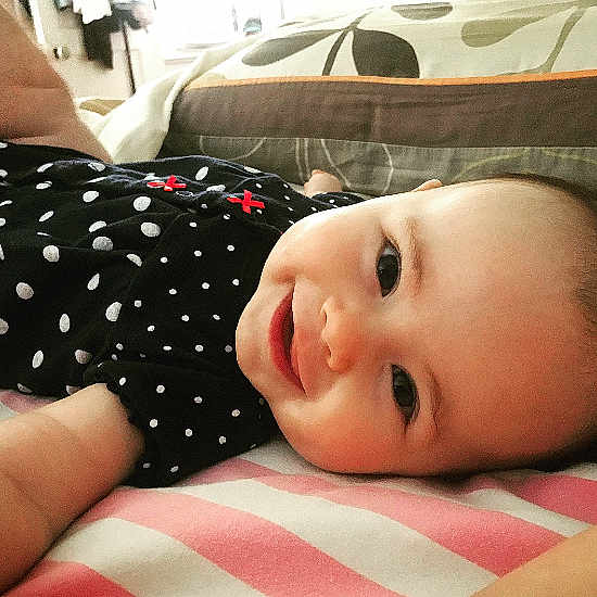 Elesemond is registered to the contest to win money with this photo: baby, baby_toddler_clothing, cheek, comfort, eye, face, facial_expression, finger, head, lip, mammal, mouth, nose, product, skin, sleeve, smile, textile, toddler, vertebrate