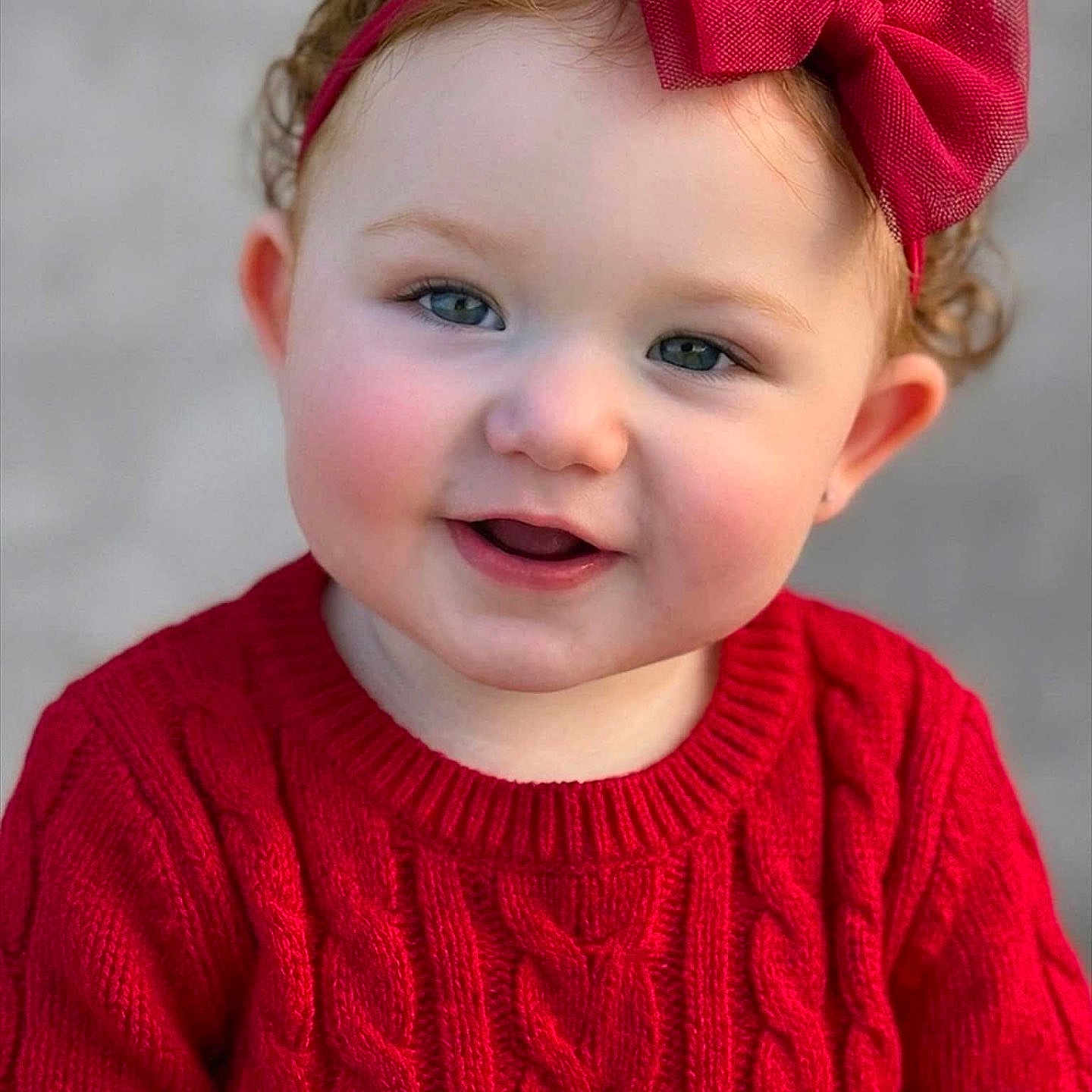 Dixianna is registered to the contest to win money with this photo: baby, blue_eyes, bow, cheeks, child, closeup, cozy, curly_hair, cute, face, fashion, happy, headband, infant, knitwear, outdoor, portrait, red_sweater, smile, warm