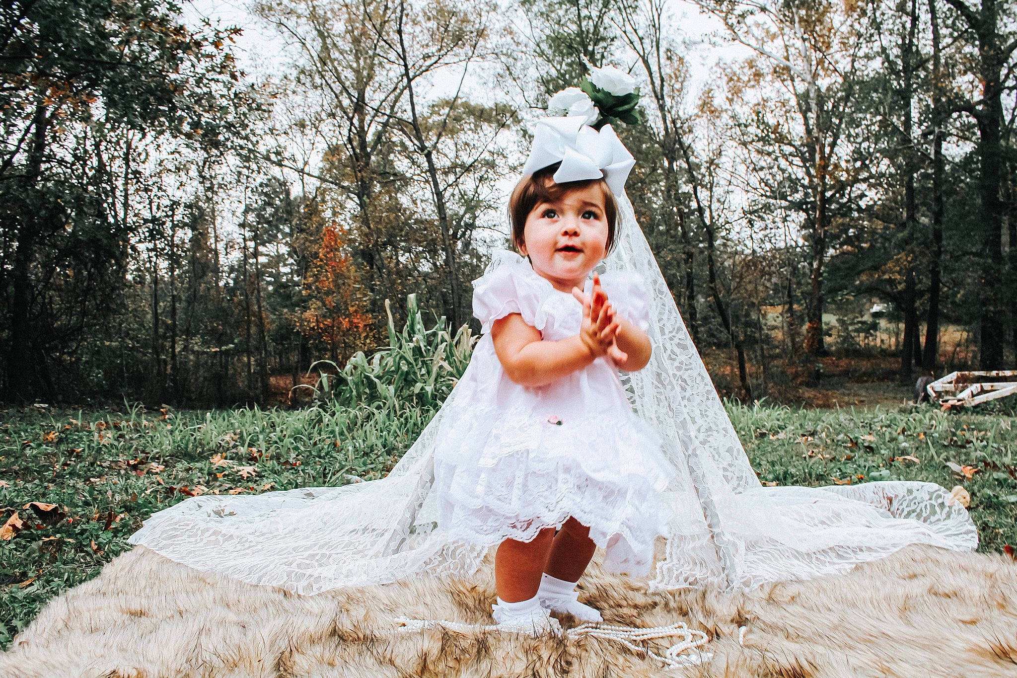 Mattie is registered to the contest to win money with this photo: baby, baby_toddler_clothing, child_model, costume_accessory, dress, embellishment, hair_accessory, headpiece, peach, people_in_nature, person, photo_shoot, portrait_photography, quinceanera, toddler, wedding_dress