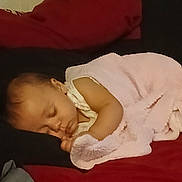 Freyja is registered to the contest to win money with this photo: baby, bed, black_bedding, blanket, child, comfort, cozy, cute, indoors, infant, peaceful, pillow, portrait, red_bedding, relaxation, resting, sleeping, soft_texture, toddler, young_child