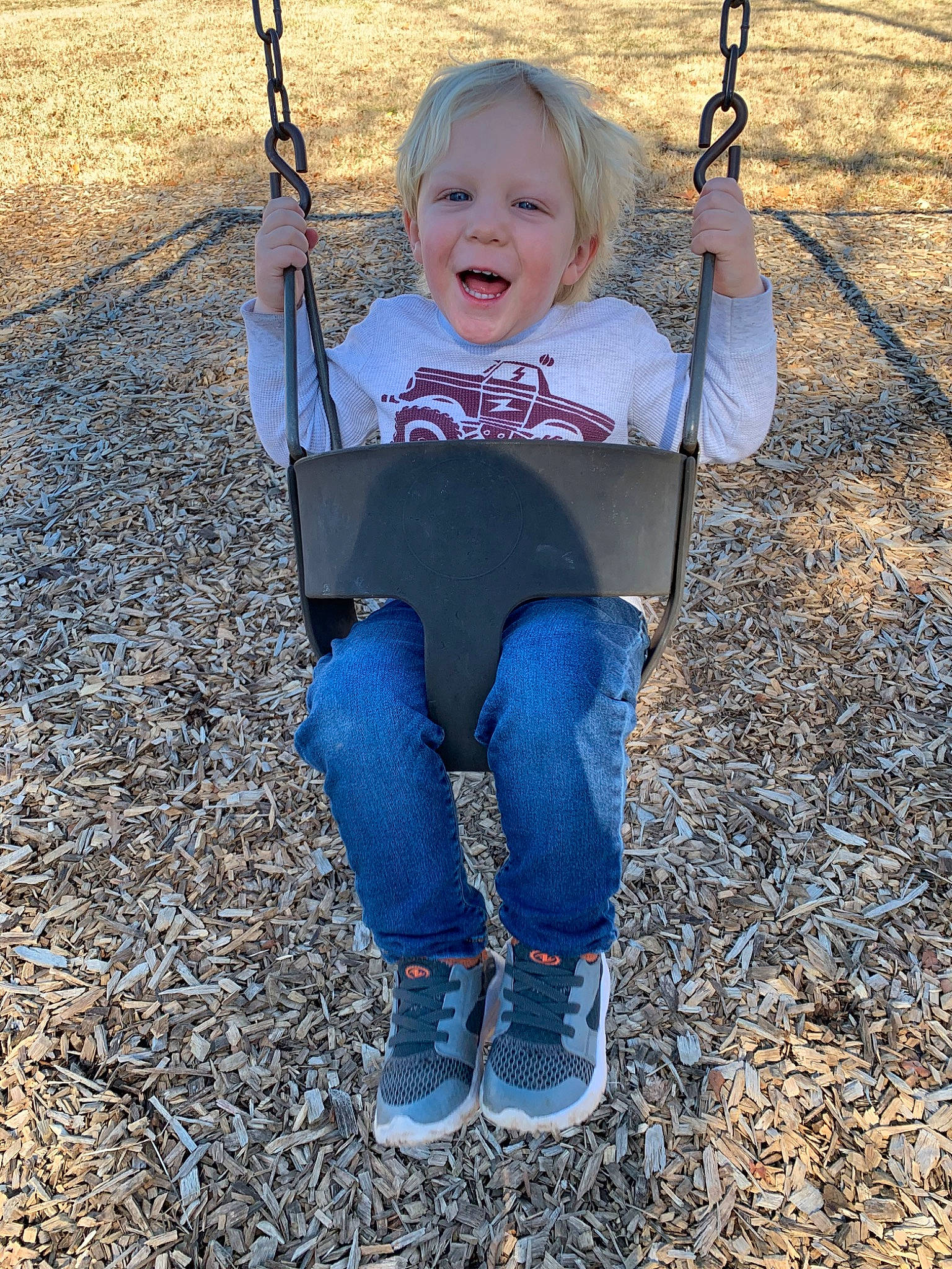 Justus joined the competition — help win amazing prizes! child, city, denim, fun, grass, happy, jeans, outdoor_play_equipment, person, plant, play, playground, public_space, recreation, smile, swing, toddler, tree