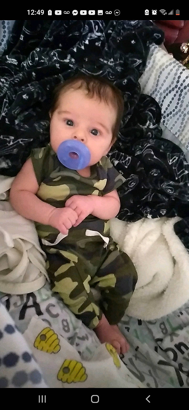 Phoenix is registered to the contest to win money with this photo: baby, baby_safety, baby_toddler_clothing, beauty, camouflage, cheek, child, comfort, eye, eyelash, face, gesture, head, iris, linens, military_camouflage, pattern, person, skin, sleeve