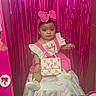 Leylani is registered to the contest to win money with this photo: baby, barbie, bow, box, child, curtain, cute, decor, dress, face, headband, indoor, person, pink, portrait, purse, sitting, small, toy, white_shoes