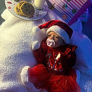 Leylani is registered to the contest to win money with this photo: baby, infant, pacifier, santa_hat, santa_outfit, cookies, milk, plate, gift_bag, blanket, tutu, socks, christmas, holiday, cozy, portrait, soft_lighting, feeding, table, present