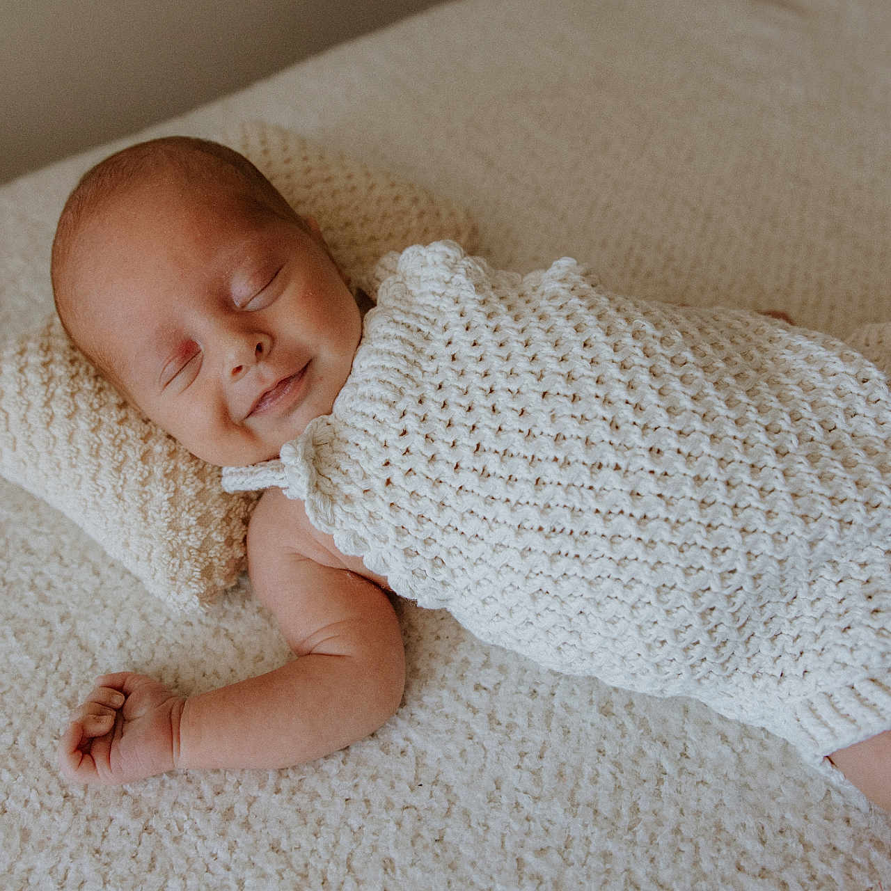 Ockert is registered to the contest to win money with this photo: baby, blanket, bodypart, clothing, cushion, face, finger, hand, happy, hat, head, homedecor, knitwear, newborn, person, photography, portrait, sleeping, smile, sweater