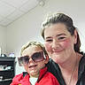 Ryder joined the competition — help win amazing prizes! child, adult, sunglasses, red_jacket, smile, indoor, woman, person, happy, face, hair, clothing, light, ceiling, shelf, toy, glasses, casual, portrait, toddler