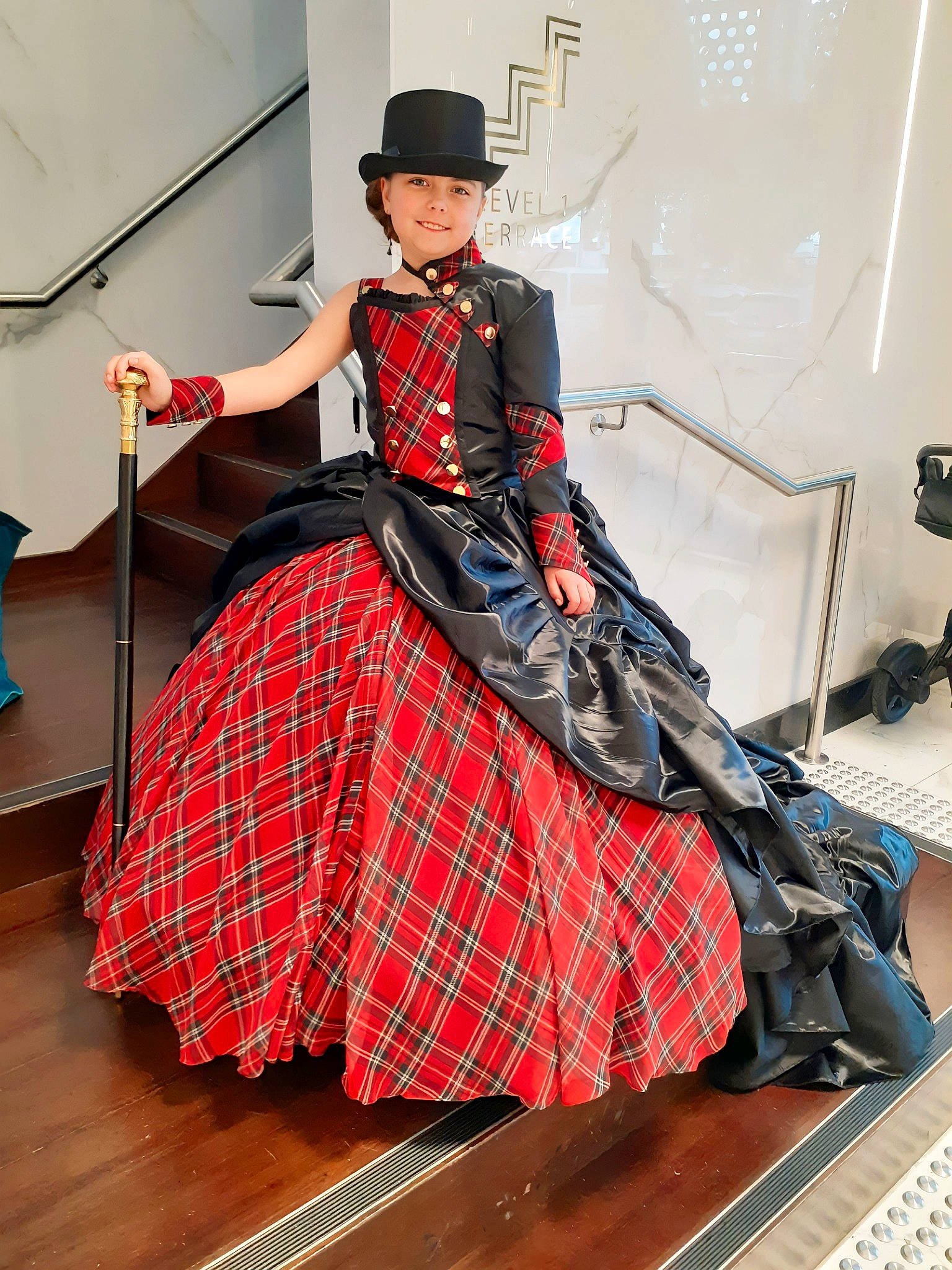 Savannah is registered to the contest to win money with this photo: belt, costume, costume_design, dress, event, fashion_accessory, fashion_design, fashion_model, flooring, formal_wear, gown, hat, headwear, joy, pattern, person, plaid, sleeve, sun_hat, tartan