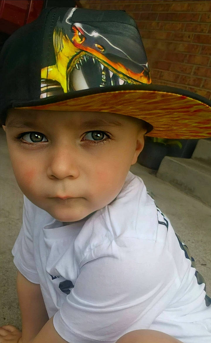 Noah is registered to the contest to win money with this photo: baseball_cap, cap, child, chin, costume_hat, cowboy_hat, electric_blue, eye, fashion_accessory, fedora, fun, hat, headgear, headwear, helmet, person, personal_protective_equipment, sports_gear, sun_hat, toddler