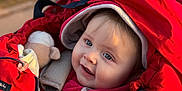 Clément participe au concours pour gagner de l'argent avec cette photo : baby, infant, child, red_bunting, stroller, hood, blanket, toy_plush, zipper, blue_eyes, smile, cheeks, cozy_clothing, outdoor, park, sunlight, portrait, warm_jacket, happy, soft_focus