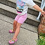 Madilynn joined the competition — help win amazing prizes! barbie, brick_wall, casual_clothing, child, concrete, crocs, footwear, grass, happy, outdoor, person, pink_shorts, playful, sidewalk, smiling, steps, summer, sunglasses, tshirt, young_girl