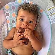 Haze joined the competition — help win amazing prizes! baby, baby_seat, chewing, child, closeup, colorful, curly_hair, cushion, cute, expression, face, hands, indoors, infant, meat, pattern, sitting, skin, toy, young