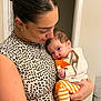 woman, baby, holding, indoor, leopard_print, striped_pants, orange_slippers, affection, love, closeup, portrait, casual_clothing, child, family, tenderness, skin, head, face, person, human