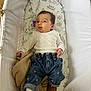 Odette joined the competition — help win amazing prizes! baby, infant, bassinet, blanket, denim_pants, heart_pattern, brown_shoes, white_clothing, indoor, cute, child, person, sleeping_area, soft_fabric, wood_floor, pacifier, playful, tongue_out, cozy, resting