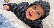 Thiago is registered to the contest to win money with this photo: baby, baby_clothing, bed, blanket, blue_blanket, child, cozy, eyes, face, happy, hood, hoodie, indoor, infant, lying_down, photography, portrait, smiling, stuffed_animal, teddy_bear