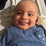 Thiago joined the competition — help win amazing prizes! baby, child, infant, smiling, tongue_out, portrait, lying_down, bed, bedding, blue_outfit, knit_clothing, indoors, cozy, close_up, face, eyes, happy, home, soft_lighting, photography