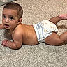 Thiago is registered to the contest to win money with this photo: baby, infant, child, diaper, crawling, lying_down, carpet, indoor, portrait, face, eyes, looking_at_camera, curious, bare_skin, brown_hair, arms, legs, floor, home, cute