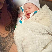 Harley joined the competition — help win amazing prizes! baby, newborn, swaddle, blanket, hospital, mother, tattoo, sleeping, infant_hat, cup, bedside_table, patient_id_band, closeup, portrait, cozy, skin, arm, face, soft_texture, hospital_bed